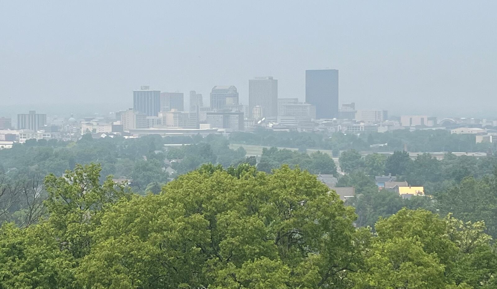 The downtown Dayton skyline is seen through a hazy smoke from Canadian wildfires on Wednesday, June 28, 2023. JEREMY P. KELLEY / STAFF