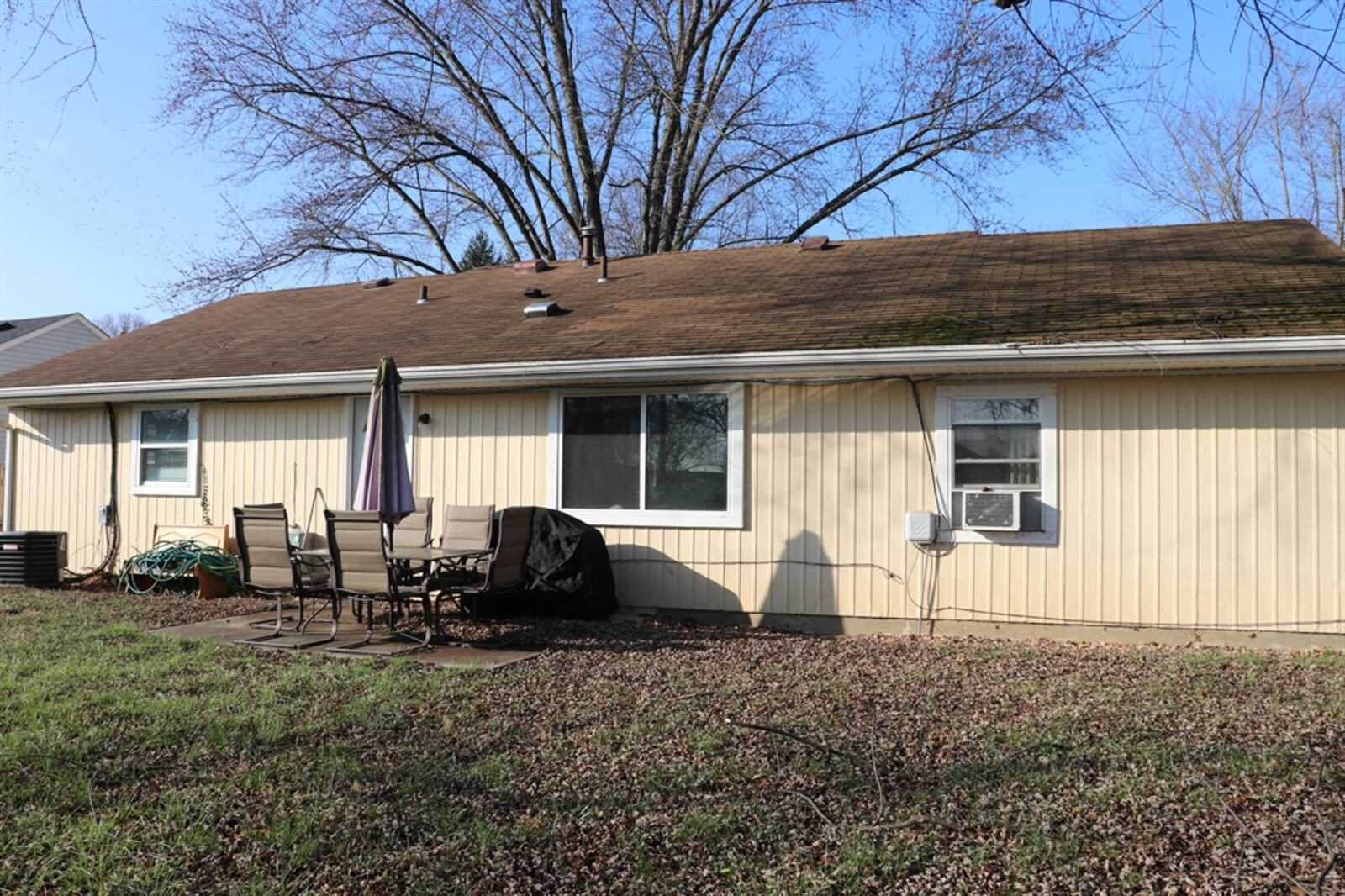 A back door opens from the laundry room out to a concrete patio and the deep backyard. 