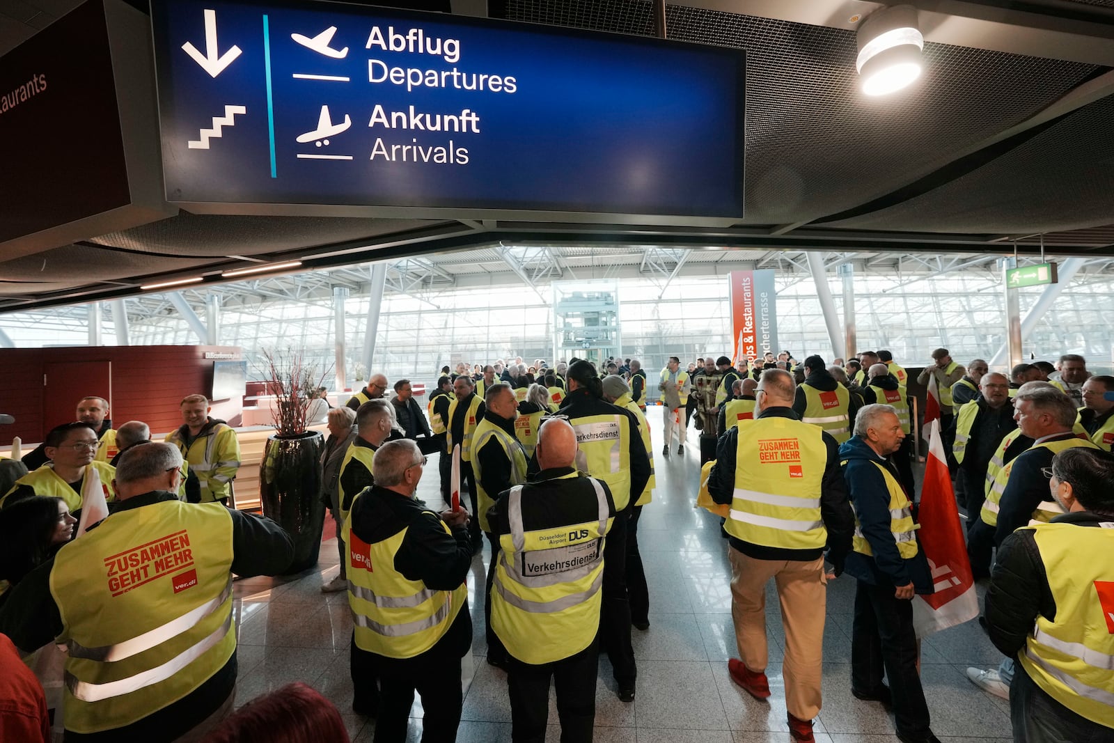 Airport workers protest during a strike of the union ver.di at the airport in Duesseldorf, Germany on Monday, March 10, 2025, when all major airports in Germany went on a warning strike. (AP Photo/Martin Meissner)