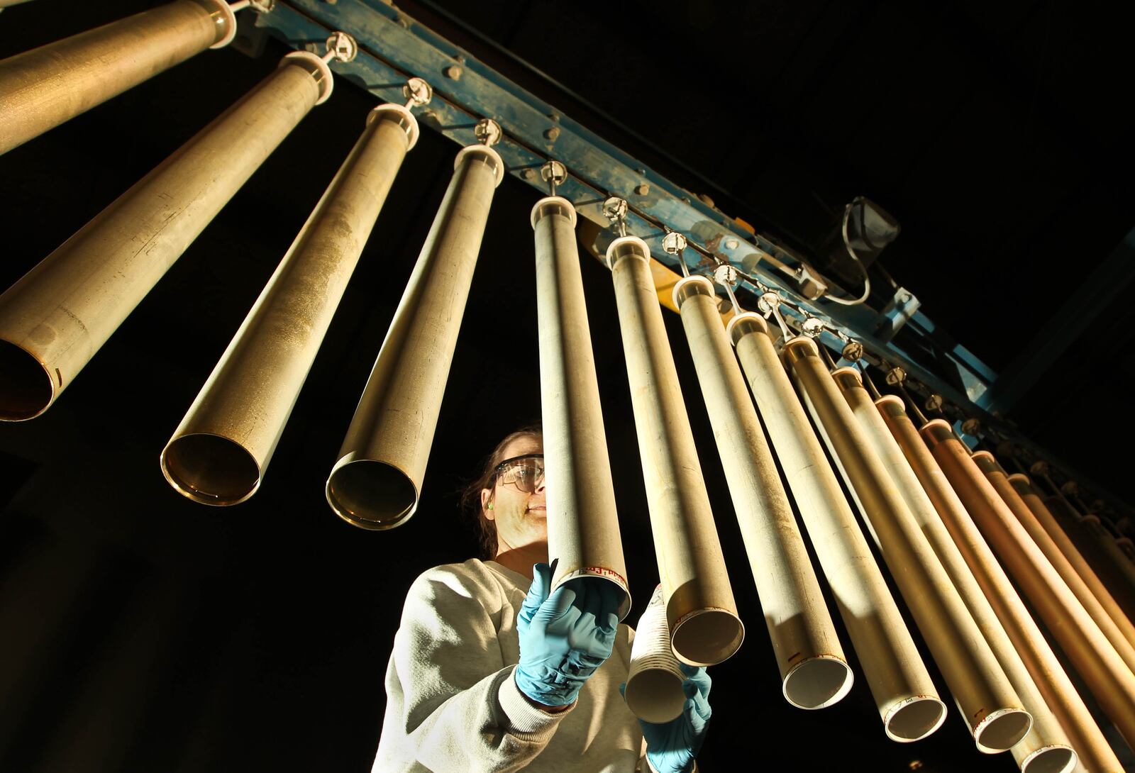 General Dynamics Production Associate Sandy Maggard preps hydra motor tubes for powder coating in this file photo. 