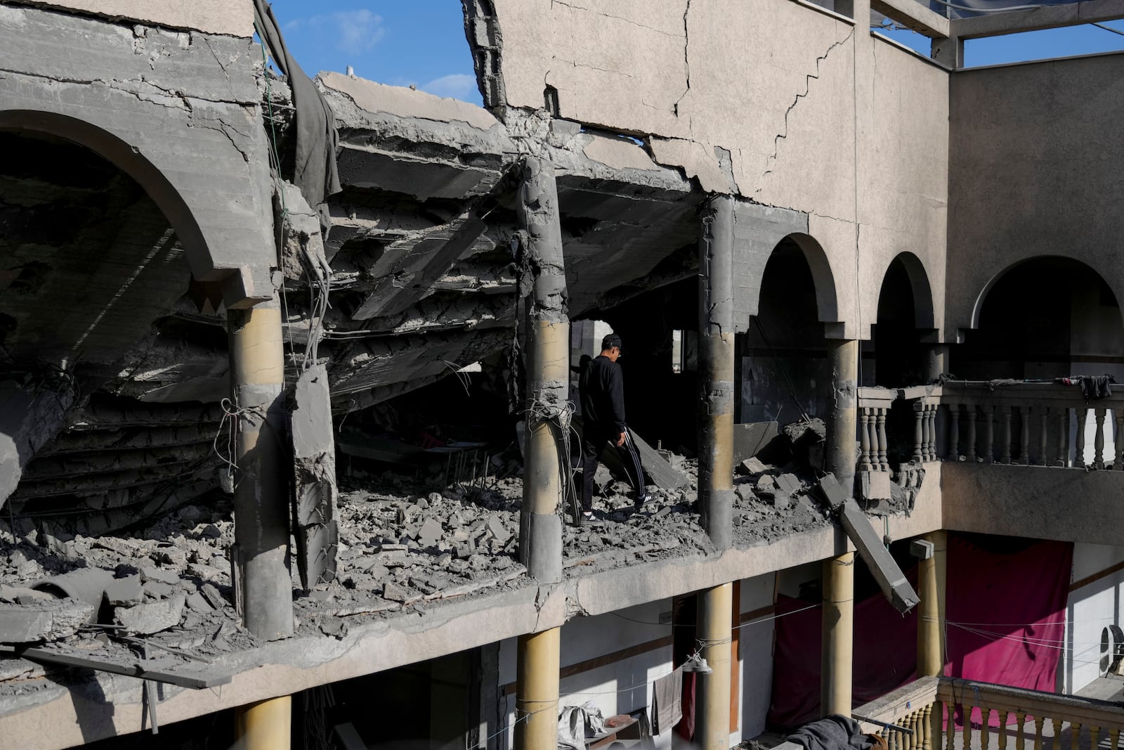 Palestinians inspect the damage at Al-Tabi'in School in central Gaza Strip following an Israeli airstrike, Tuesday, March 18, 2025. (AP Photo/Jehad Alshrafi)