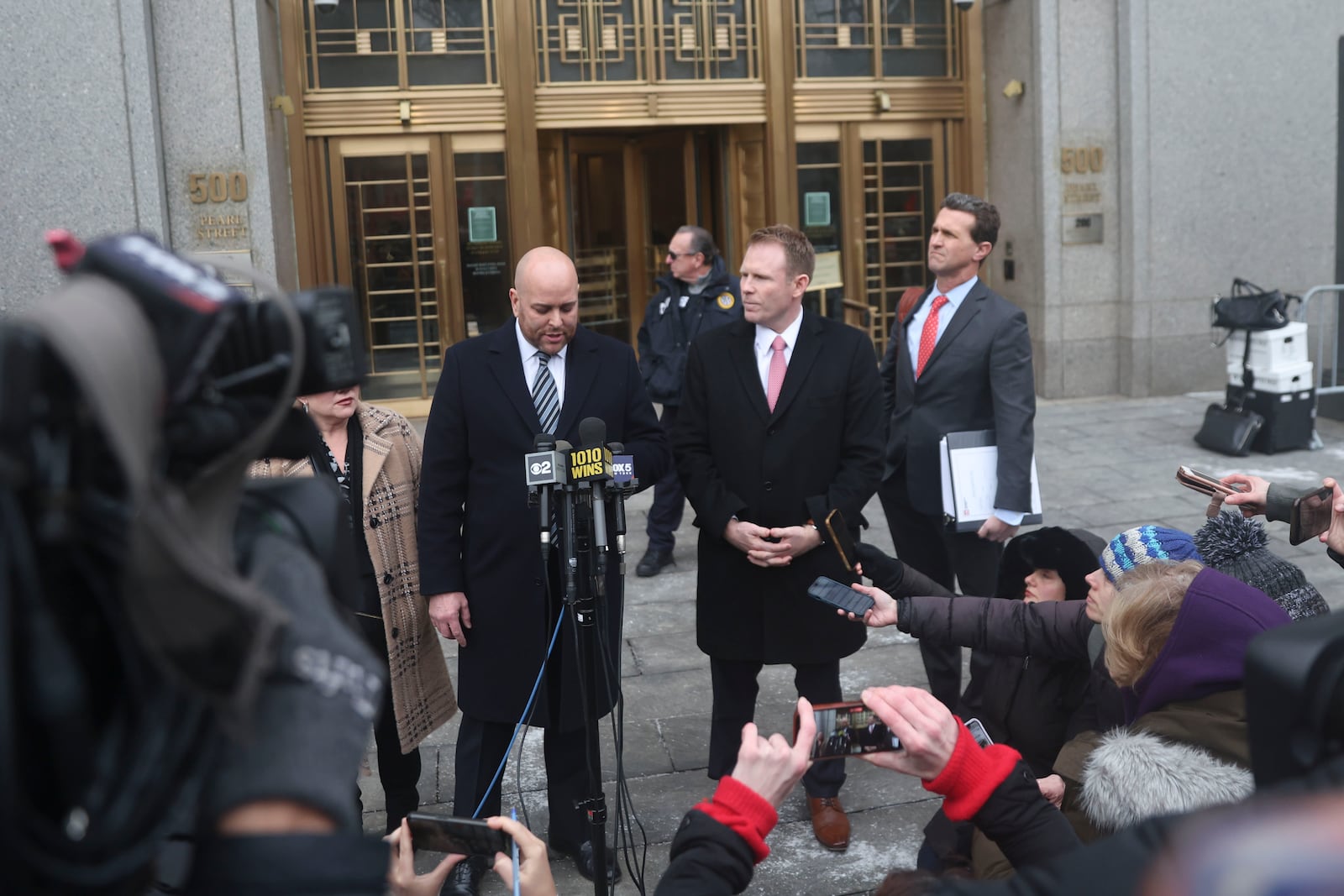 Attorney Joseph Cammarata, left, reads a statement off his phone on behalf of Rudy Giuliani outside of federal court, Thursday, Jan. 16, 2025, in New York. (AP Photo/Heather Khalifa)