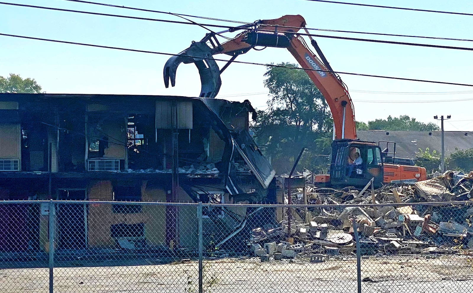 Crews work to demolish the Villager Inn on Saturday, Aug. 19, 2023, in Springfield. The city purchased the hotel in December for $1.7 million for use as a homeless shelter, but took emergency action last week to demolish the building instead. BEN MCLAUGHLIN/STAFF