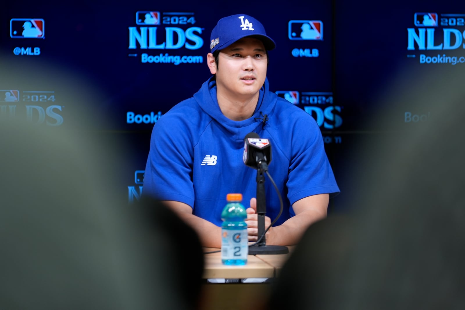 Los Angeles Dodgers' Shohei Ohtani fields questions ahead of Game 5 of a baseball National League Division Series against the San Diego Padres, Thursday, Oct. 10, 2024, in Los Angeles. (AP Photo/Ashley Landis)