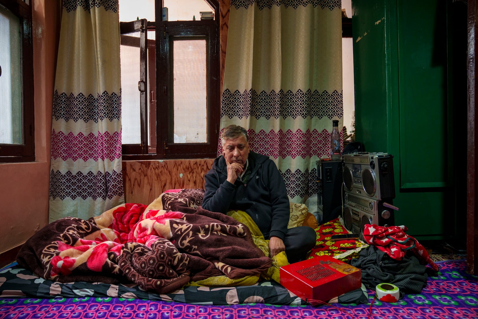 Abdul Hamid Khan listens to Kashmiri Sufi music on a tape recorder in his room in downtown Srinagar, Indian controlled Kashmir, Friday, Feb. 21, 2025. (AP Photo/Dar Yasin)