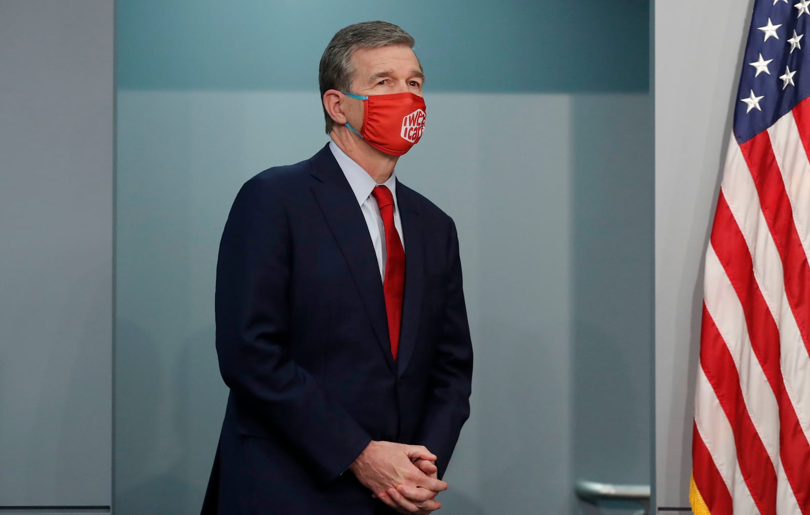 FILE - Gov. Roy Cooper heads back to the podium to answer questions during a briefing at the Emergency Operations Center in Raleigh, N.C., Tuesday, Feb. 2, 2021. (Ethan Hyman/The News & Observer via AP, File)