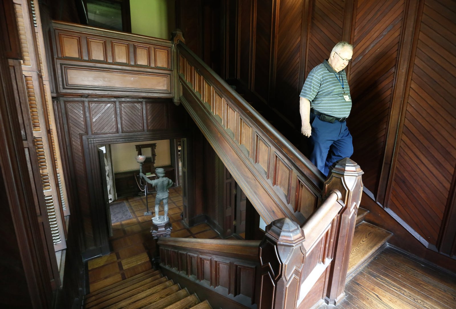 Jim Heiser, an interpreter at the Piatt Castles for 14 years, descends a staircase at Mac-O-Chee. The home was constructed in two sections beginning in the 1860s and completed in the 1880s. LISA POWELL / STAFF