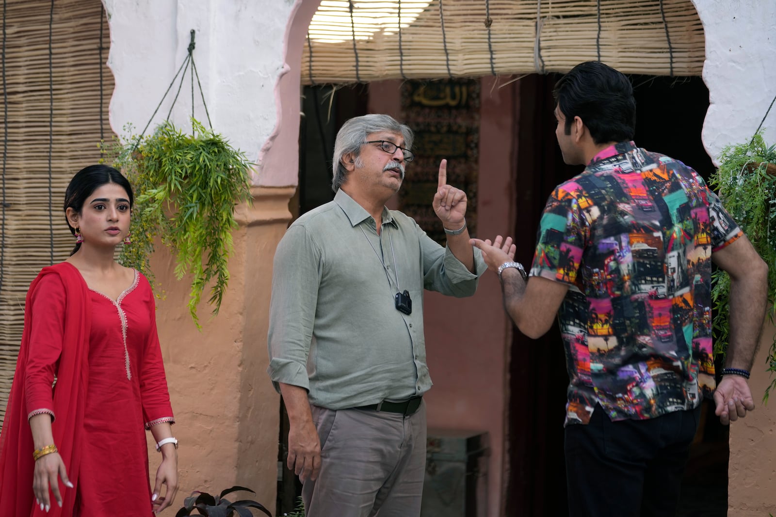 Pakistani tv actor and producer Saife Hassan, center, talks with actor Usman Javed, right, and actress Sehar Khan, left, on the set during the shooting of a scene of tv drama serial 'Tan Man Neel-o-Neel' or 'Deeply Engrossed in Love', in Rawalpindi, Pakistan, Saturday, Nov. 2, 2024. (AP Photo/Anjum Naveed)