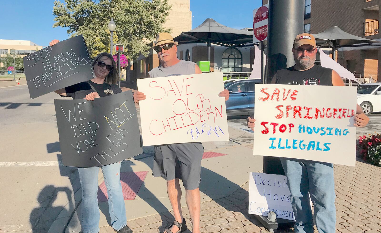 Pictured (L to R) are Melissa and Jay Durst and a man who wished not to be identified who joined other Springfield residents expressing frustration following a fatal school bus accident that resulted in vehicular homicide charges against Haitian immigrant Hemanio Joseph. Citizens demanded action from city officials, who say they have a limited role in addressing immigrant issues. CONTRIBUTED BY VICKY FORREST