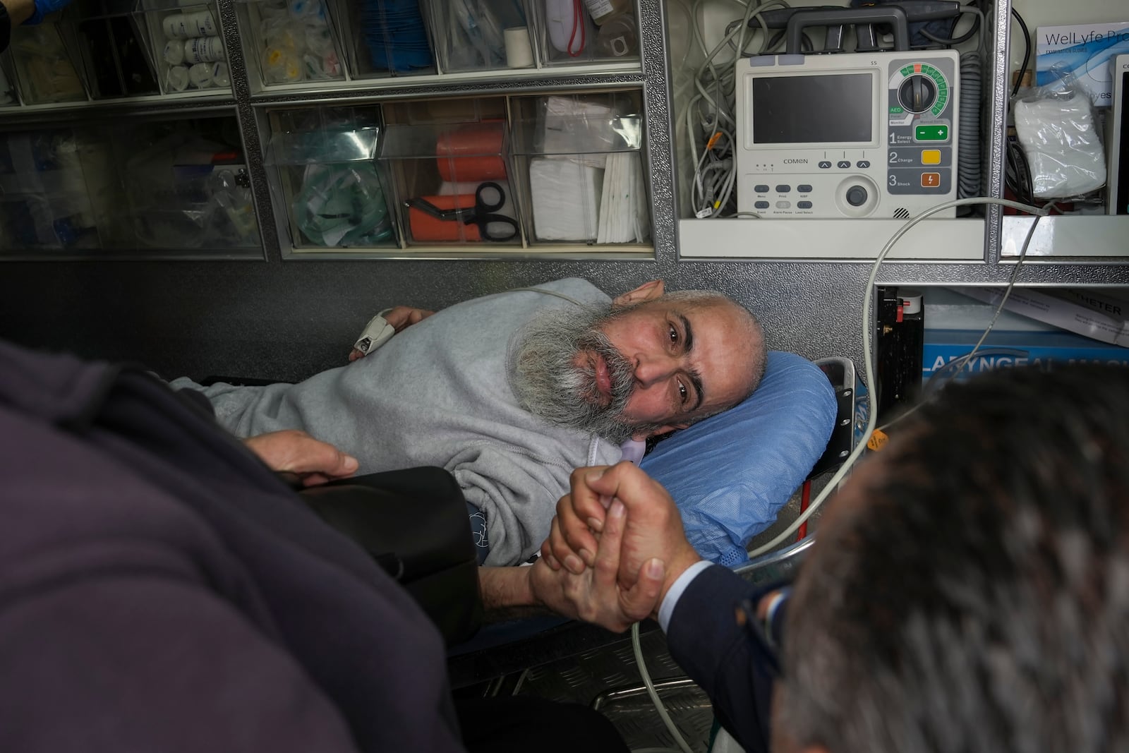 Palestinian prisoner Hussam Shaheen is greeted as he is taken in an ambulance for a medical check after being released from an Israeli prison following a ceasefire agreement between Israel and Hamas, in the West Bank city of Ramallah, Saturday Feb. 1, 2025. (AP Photo/Mahmoud Illean)