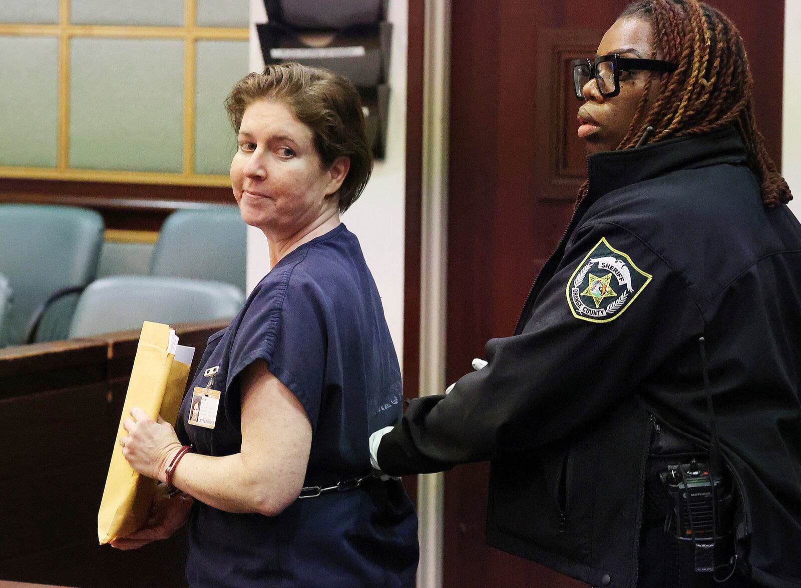 Sarah Boone smiles as she is led off in handcuffs in a courtroom of the Orange County Courthouse in Orlando, Florida, on Monday, Dec. 2, 2024. (Stephen M. Dowell/Orlando Sentinel via AP)