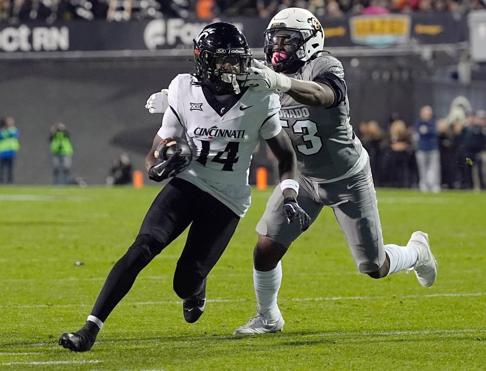 Cincinnati wide receiver Barry Jackson Jr., left, is stopped after a short gain by Colorado defensive end Arden Walker in the first half of an NCAA college football game Saturday, Oct. 26, 2024, in Boulder, Colo. (AP Photo/David Zalubowski)