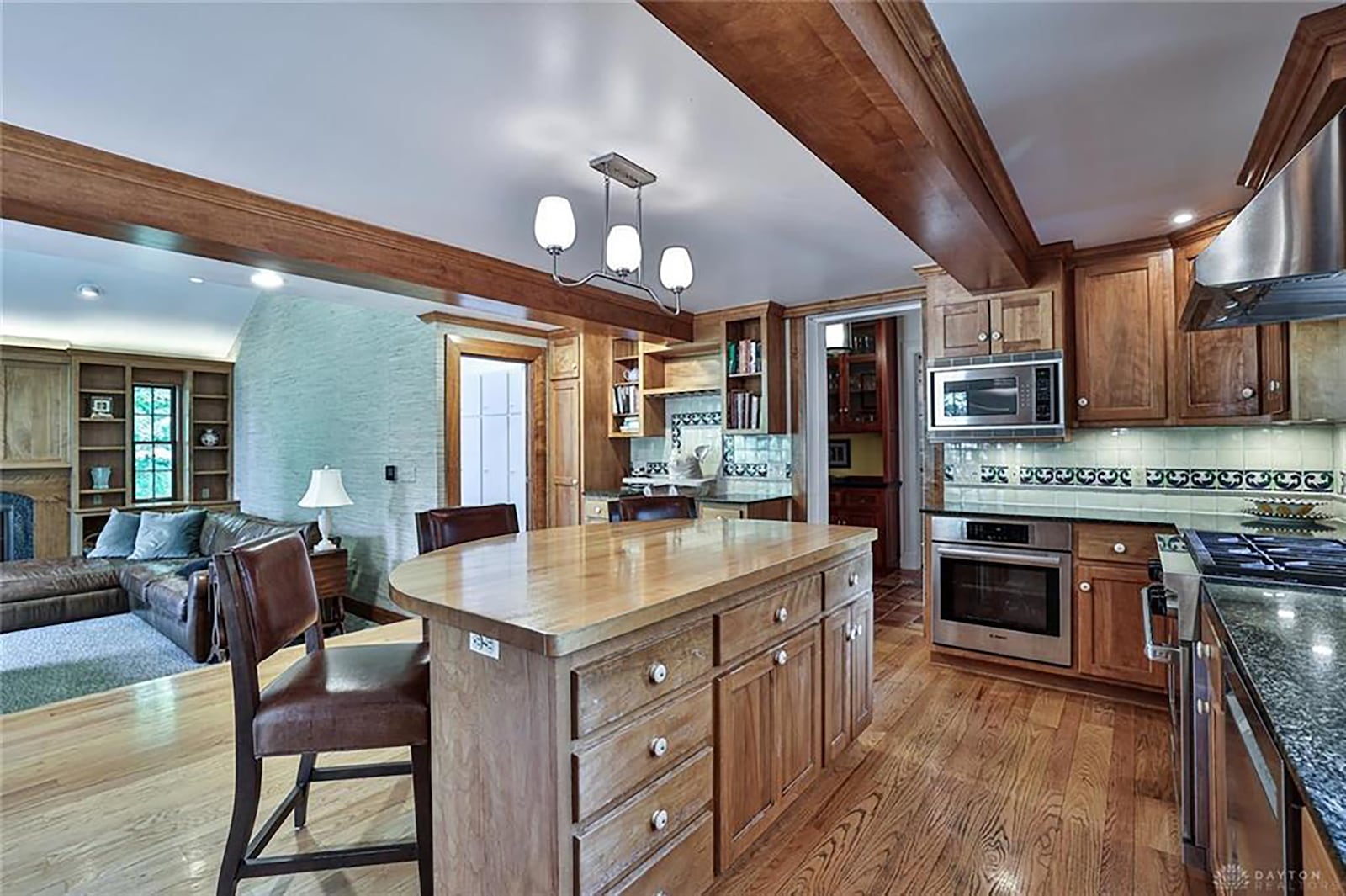 The updated kitchen has wood cabinets and high end appliances as well as a planning desk.