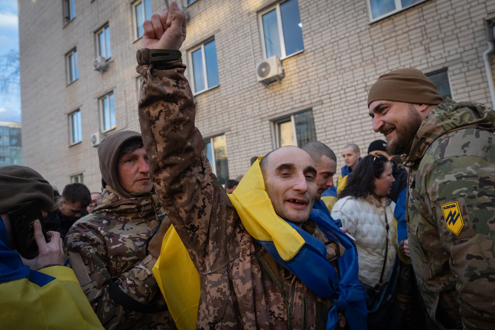 A Ukrainian serviceman reacts after returning from captivity during a POWs exchange between Russia and Ukraine, in Chernyhiv region, Ukraine, Wednesday, March 19, 2025. (AP Photo/Efrem Lukatsky)