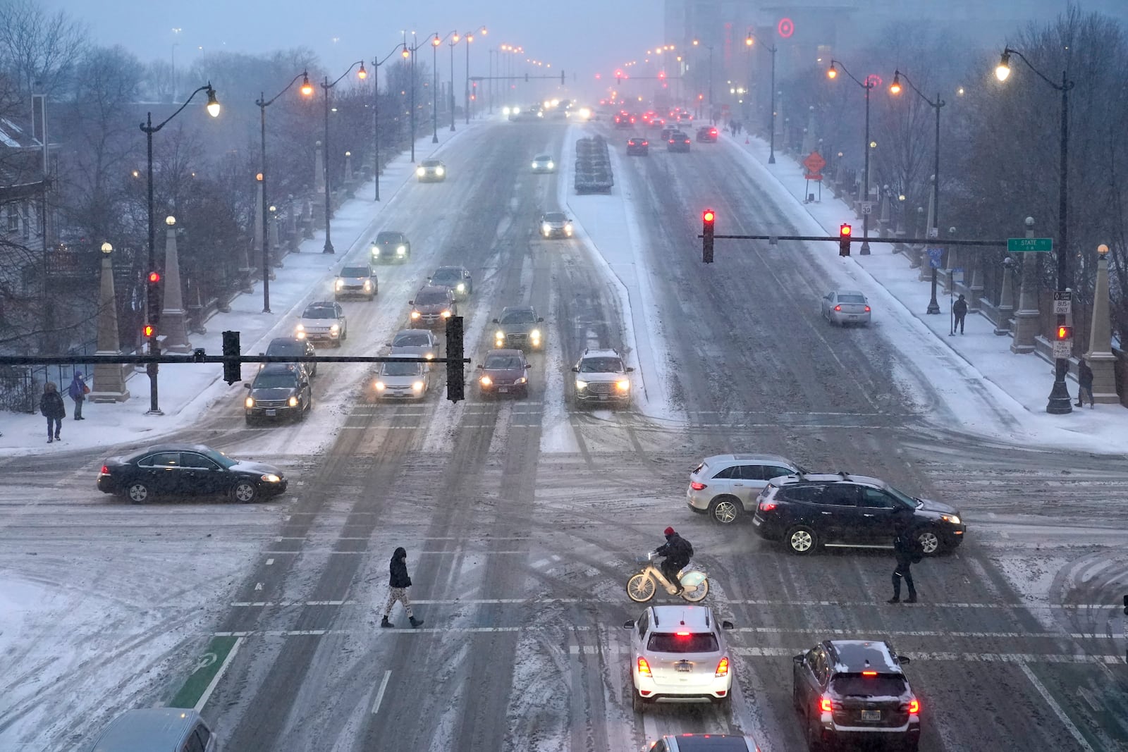 FILE - Pedestrians navigate slippery streets Thursday, Dec. 22, 2022, in Chicago. (AP Photo/Charles Rex Arbogast, File)