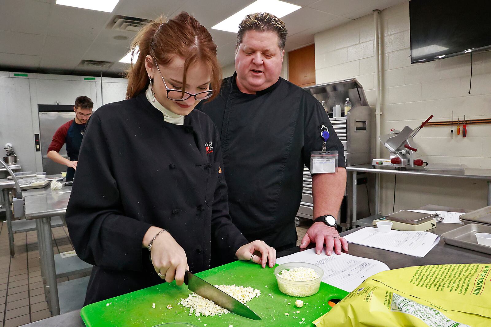 CTC Culinary Arts Instructor Chef David Hay guides student Ainslee Whited and others as they practice for a competition on Friday, Jan. 13, 2023. BILL LACKEY/STAFF