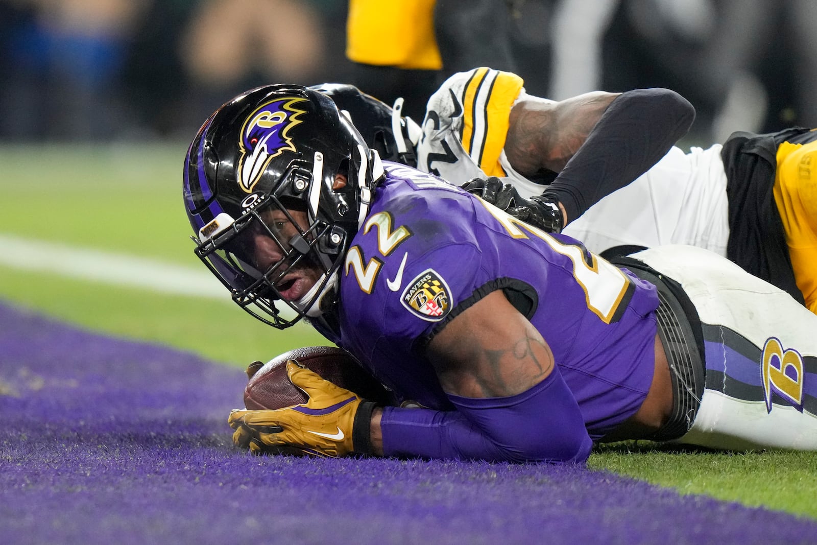 Baltimore Ravens running back Derrick Henry, front, looks on after scoring a touchdown in front of Pittsburgh Steelers safety DeShon Elliott during the first half of an NFL wild-card playoff football game, Saturday, Jan. 11, 2025, in Baltimore. (AP Photo/Stephanie Scarbrough)