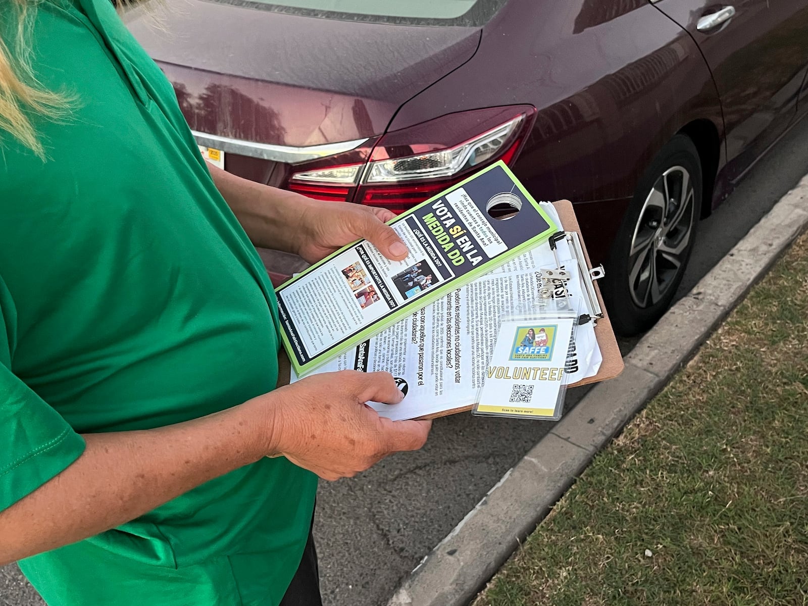 FILE -Volunteers go door-knocking on Wednesday, Oct. 23, 2024, in a Santa Ana neighborhood to encourage them to vote for Measure DD, which would allow noncitizens to vote in local elections. (AP Photo/Jaimie Ding, File)