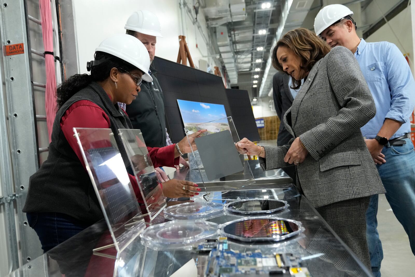 Democratic presidential nominee Vice President Kamala Harris, right, tours the Hemlock Semiconductor Next-Generation Finishing facility in Hemlock, Mich., Monday, Oct. 28, 2024. (AP Photo/Jacquelyn Martin)