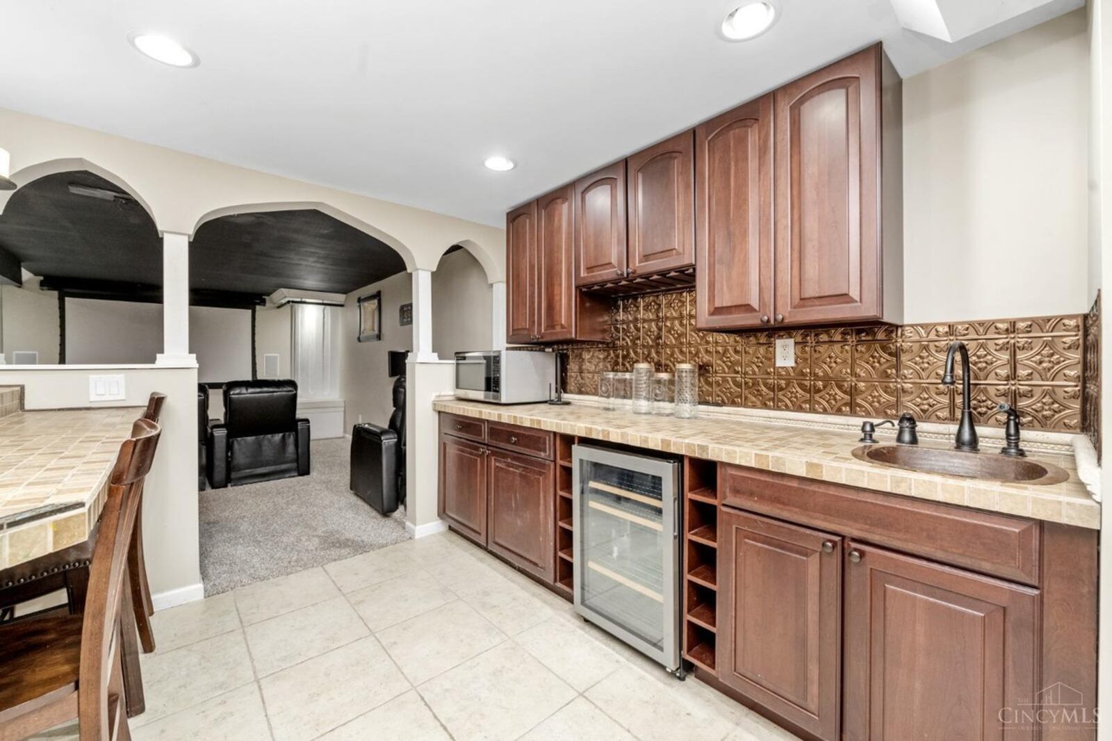 The finished basement features a recreation room with wet bar and a theater room.