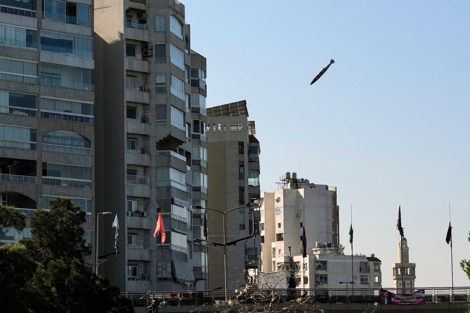 A bomb dropped from an Israeli jet prepares to hit a building in Tayouneh, Beirut, Lebanon, Friday, Nov. 15, 2024. (AP Photo/Hassan Ammar)