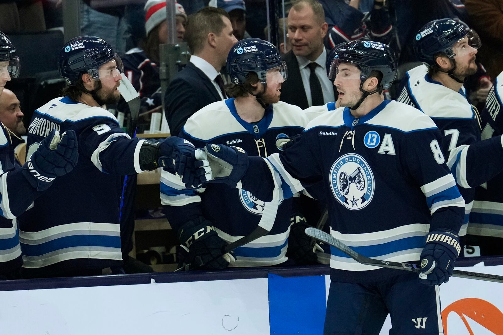 Columbus Blue Jackets defenseman Zach Werenski (8) is congratulated by teammates after scoring in the first period of an NHL hockey game against the Philadelphia Flyers Tuesday, Jan. 14, 2025, in Columbus, Ohio. (AP Photo/Sue Ogrocki)