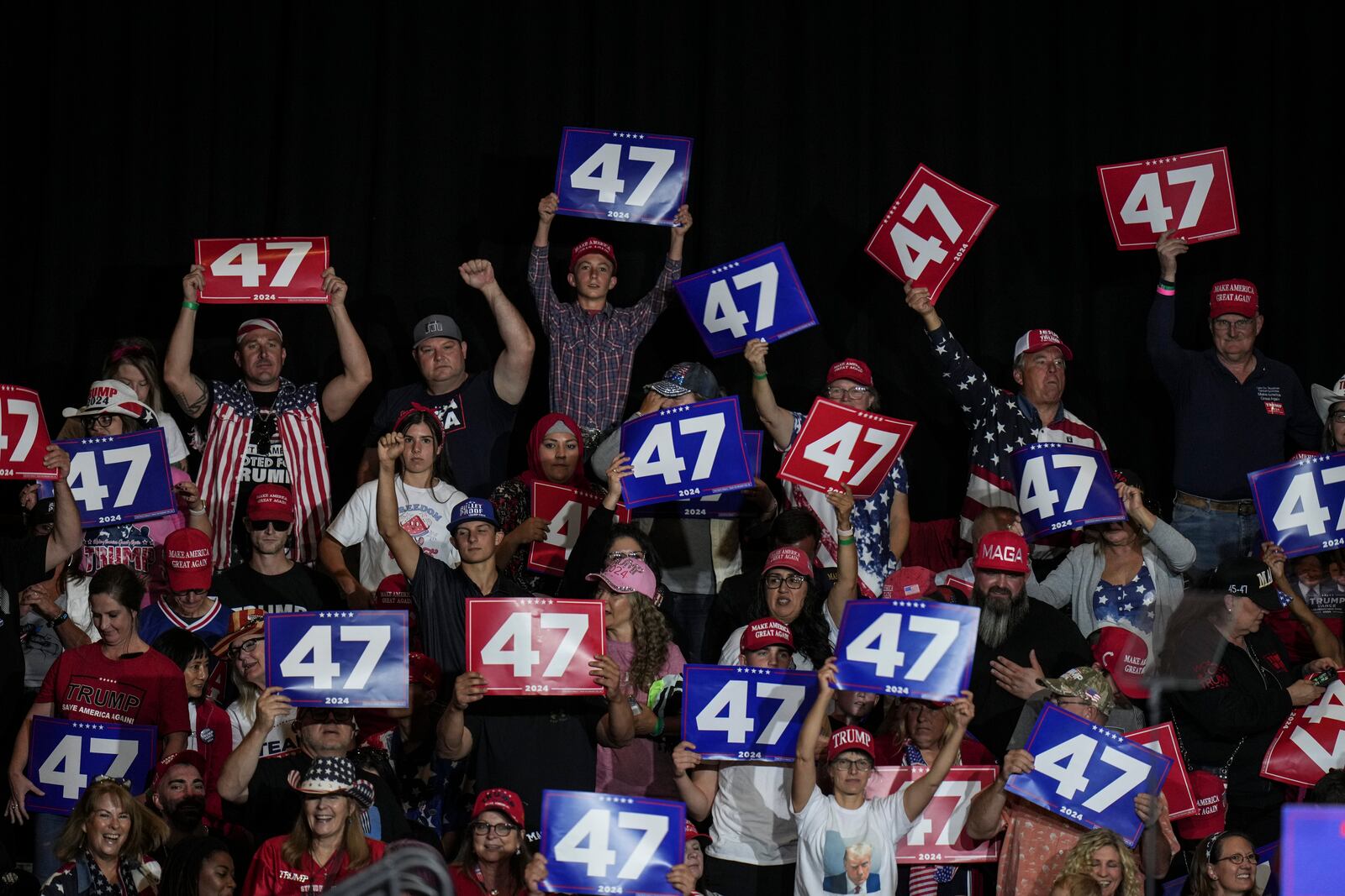 Supporters hold up signs during a campaign rally with Republican presidential nominee former President Donald Trump at Grand Sierra Resort and Casino in Reno, Nev., Friday, Oct. 11, 2024. (AP Photo/Jae C. Hong)