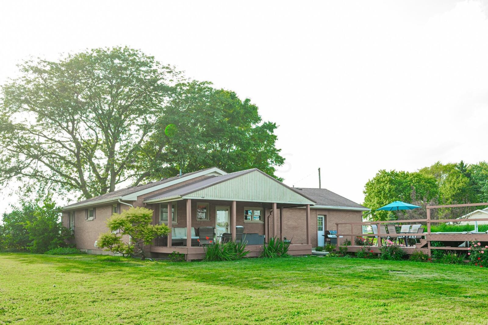 The back of the home has a covered deck and an above-ground pool with a surrounding deck with railings. Contributed