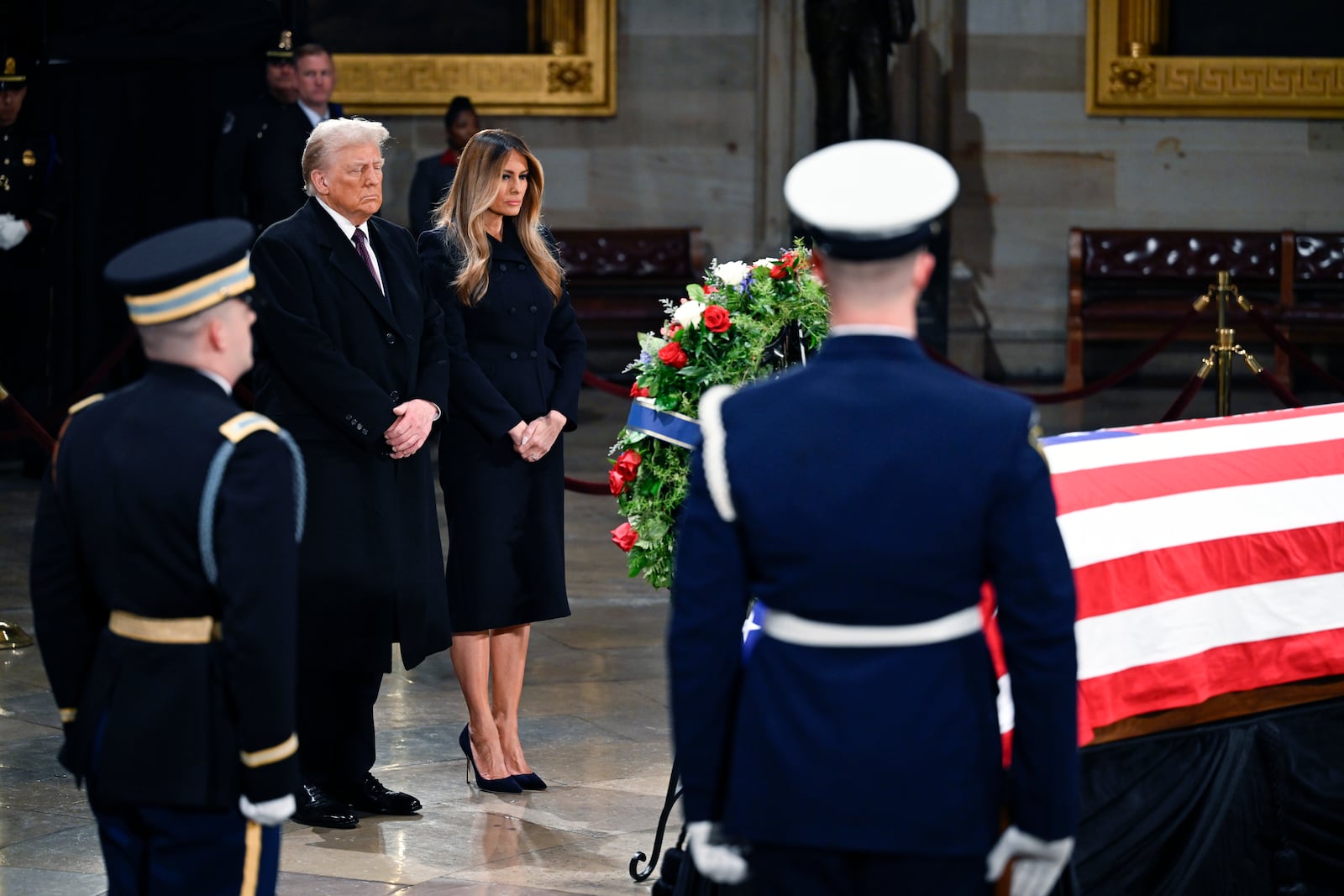 President elect Donald Trump and his wife Melania Trump visit the flag draped casket of the late former President Jimmy Carter as he lies in state at the Rotunda of the U.S. Capitol on Wednesday, Jan. 8, 2025, in Washington. (AP Photo/John McDonnell)