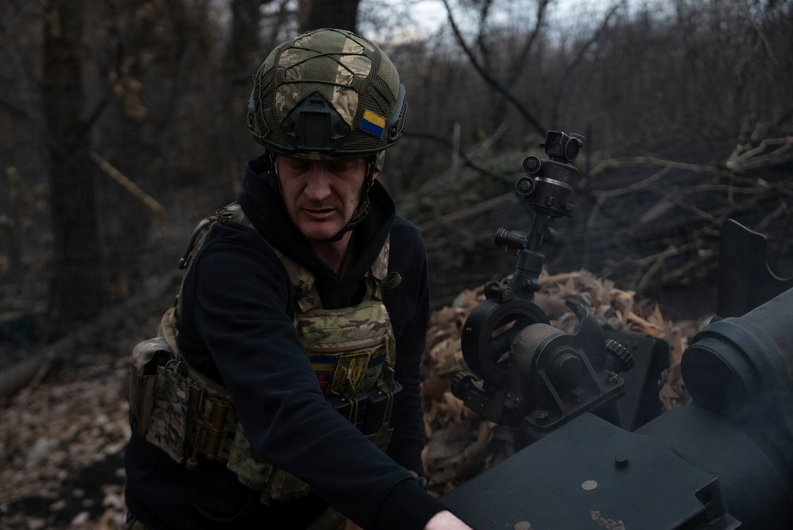 Ukrainian serviceman of Khartia brigade known by call sign "Krystal" check M101 Howitzer after firing towards Russian positions in Kharkiv region, Ukraine, Wednesday, March 12, 2025. (AP Photo/Alex Babenko)