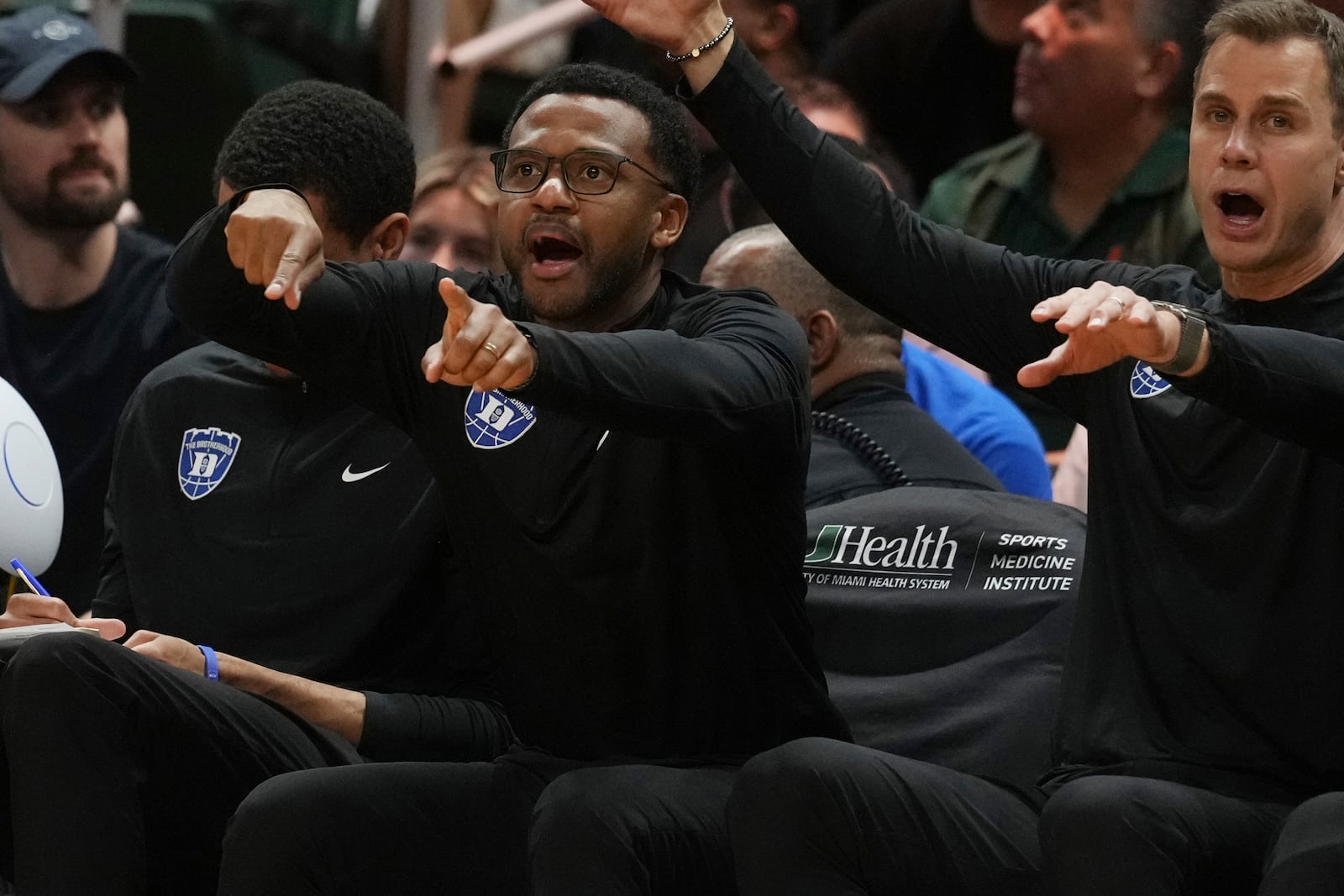 Duke associate coach Jai Lucas and head coach Jon Scheyer gesture during the second half of an NCAA college basketball game against Miami , Tuesday, Feb. 25, 2025, in Coral Gables, Fla. (AP Photo/Marta Lavandier)