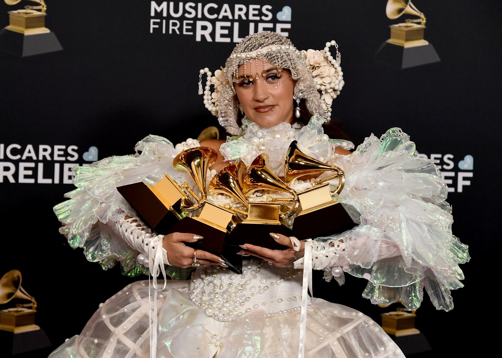 Sierra Ferrell poses in the press room with her awards for best American roots performance, best American roots song, best Americana performance and best Americana album during the 67th annual Grammy Awards on Sunday, Feb. 2, 2025, in Los Angeles. (Photo by Richard Shotwell/Invision/AP)