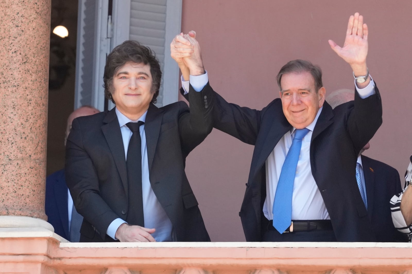 Venezuela's opposition leader Edmundo Gonzalez Urrutia, right, and Argentine President Javier Milei hold hands from the government house balcony in Buenos Aires, Argentina, Saturday, Jan. 4, 2025. Gonzalez, who claims he won the 2024 presidential election and is recognized by some countries as the legitimate president-elect, traveled from exile in Madrid to Argentina. (AP Photo/Natacha Pisarenko)