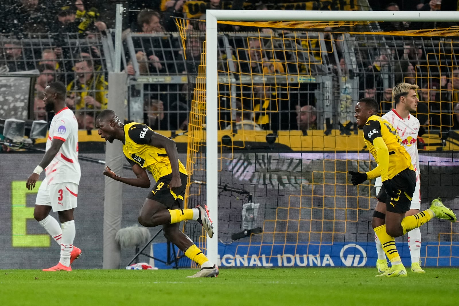 Dortmund's Serhou Guirassy, left, celebrates after he scored during the German Bundesliga soccer match between Borussia Dortmund and RB Leipzig at the Signal-Iduna Park in Dortmund, Germany, Saturday, Nov. 2, 2024. (AP Photo/Martin Meissner)