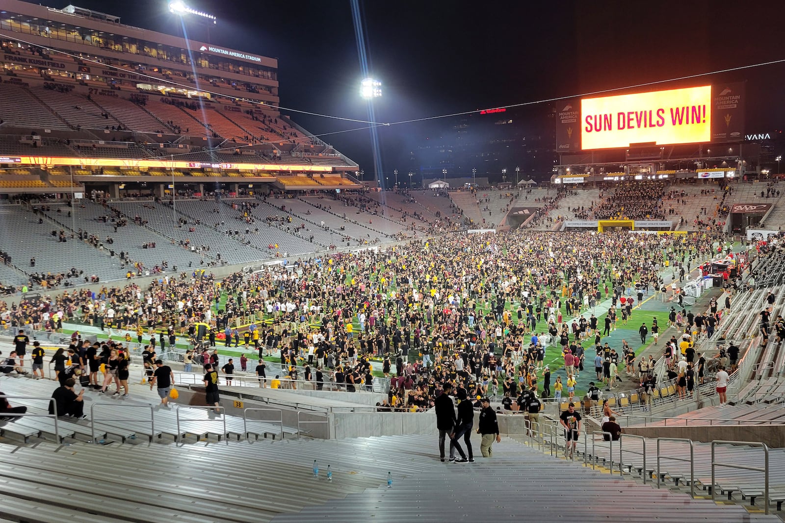 Arizona State fans rush the field after defeating Utah 27-19 during an NCAA college football game, Friday, Oct. 11, 2024, in Tempe, Ariz. (AP Photo/Rick Scuteri)