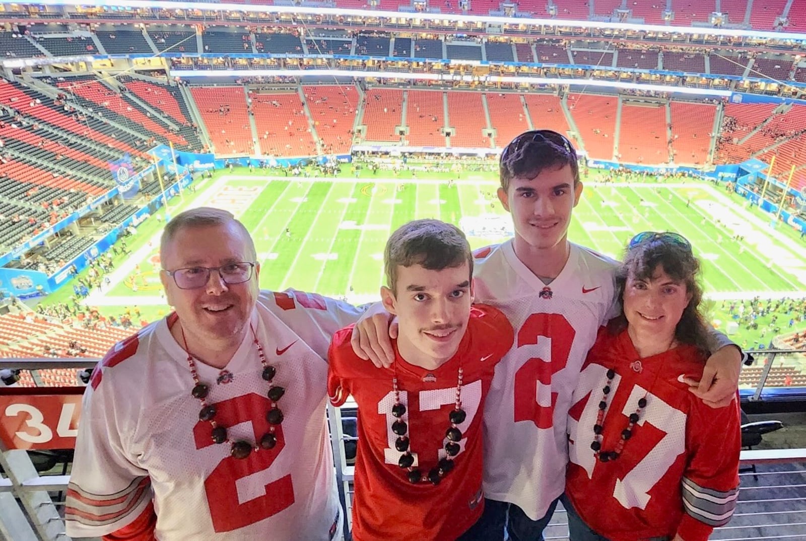 The Pullins family, of Dayton, is pictured at Mercedes Benz Stadium in Atlanta prior to the 2022 Peach Bowl between Ohio State and George. Pictured are (left to right): Duane Pullins; Camden Thomas Hayes Pullins; Christian Joseph Tressel Pullins; and Julie Pullins. Contributed photo