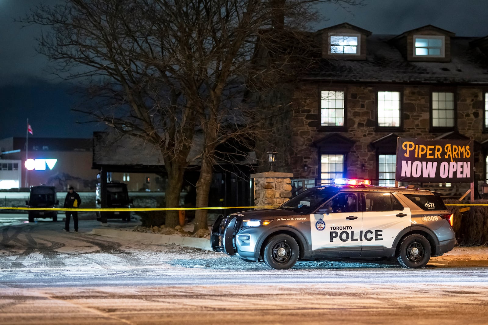 Toronto Police investigate a shooting at the Piper Arms Pub near the Scarborough Town Centre in Toronto on Saturday, March 8, 2025. (Christopher Katsarov/The Canadian Press via AP)