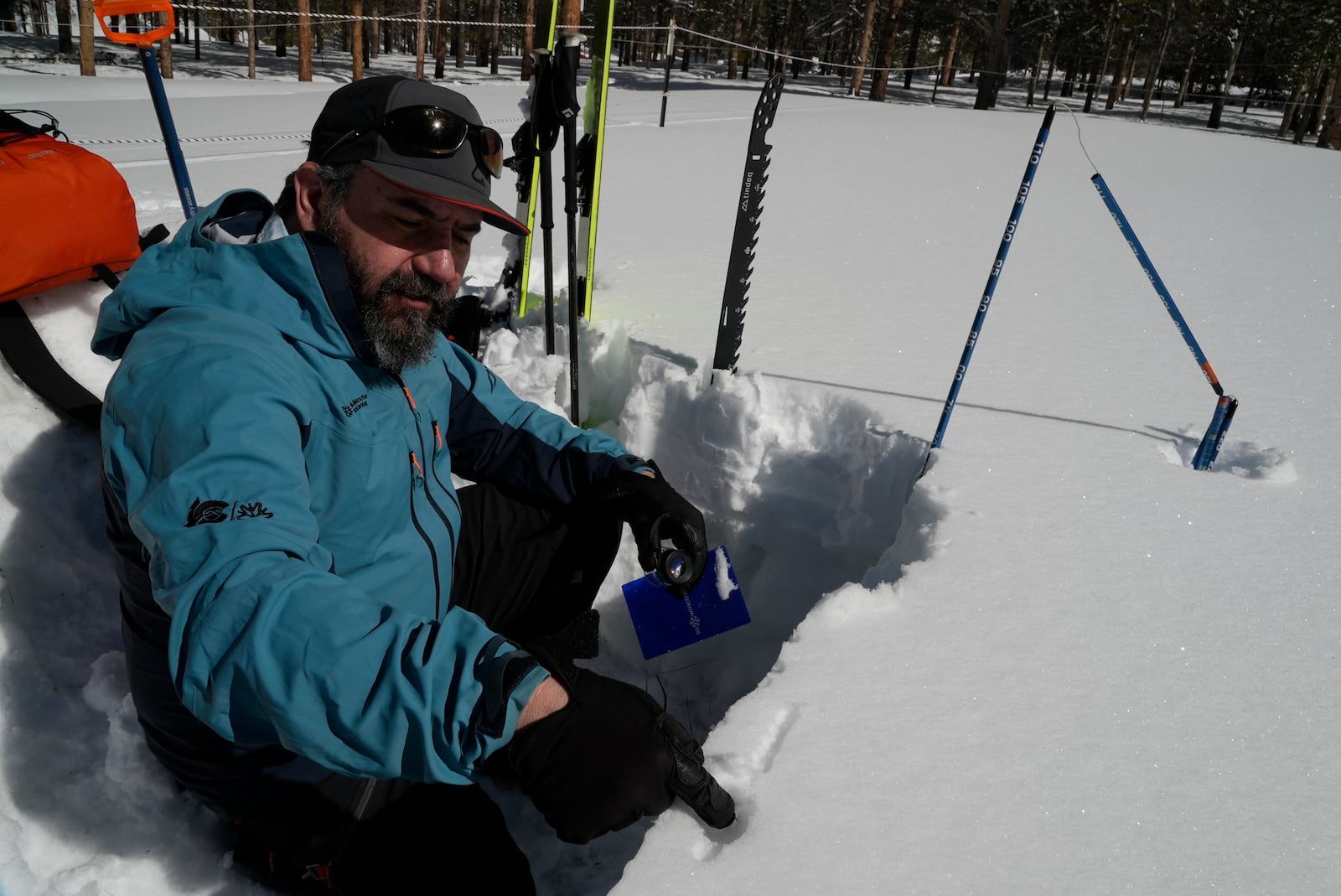 Ethan Greene, director of the Colorado Avalanche Information Center, tests layers in a demonstration snow pit Wednesday, March 5, 2025, in Leadville, Colo. (AP Photo/Brittany Peterson)