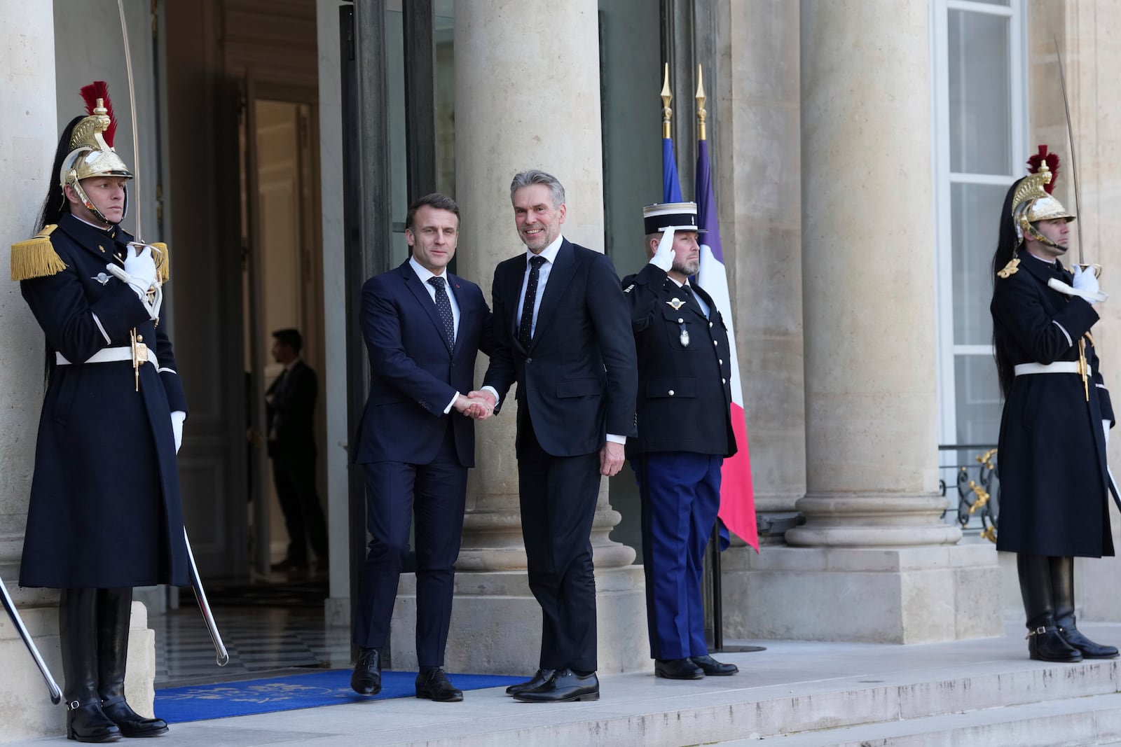 French President Emmanuel Macron, left, greets Netherland's Prime Minister Dick Schoof as he arrives for an informal meeting of leaders from key European Union nations and the United Kingdom at the Elysee Palace in Paris, Monday, Feb. 17, 2025. (AP Photo/Aurelien Morissard)