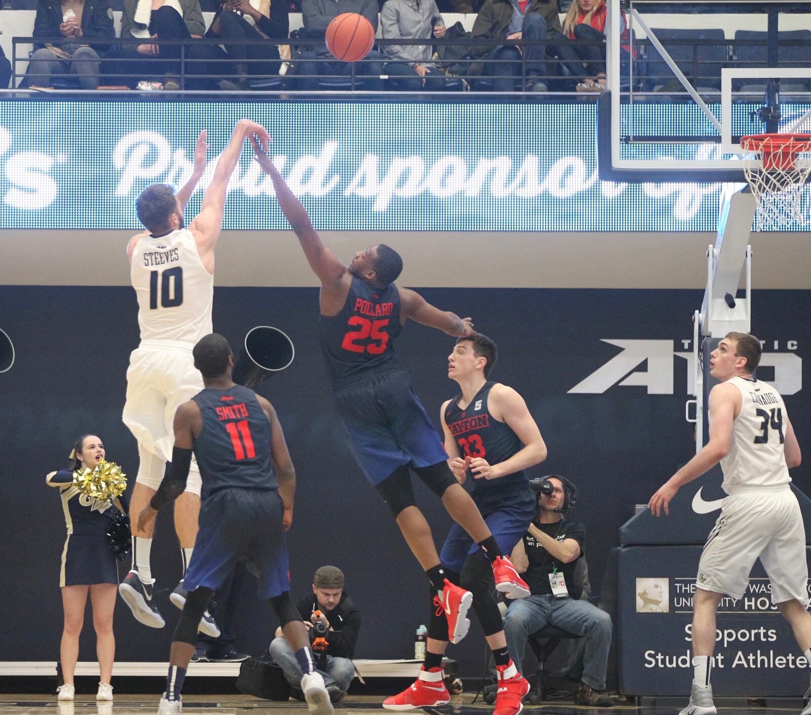 George Washington’s Patrick Steeves makes a shot against Dayton’s Kendall Pollard in the opening minutes on March 4, 2017, at the Smith Center in Washington, D.C.