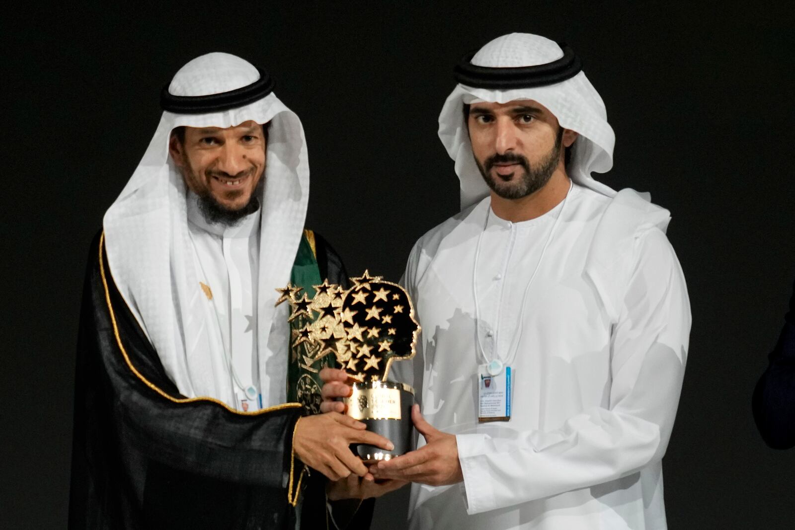 Saudi Arabian teacher Mansour bin Abdullah Al-Mansour, left, receives the Global Teacher Prize trophy from Dubai Crown Prince Sheikh Hamdan bin Mohammed Al Maktoum at a ceremony awarding the Global Teacher Prize in Dubai, United Arab Emirates, Thursday, Feb. 13, 2025. (AP Photo/Altaf Qadri)