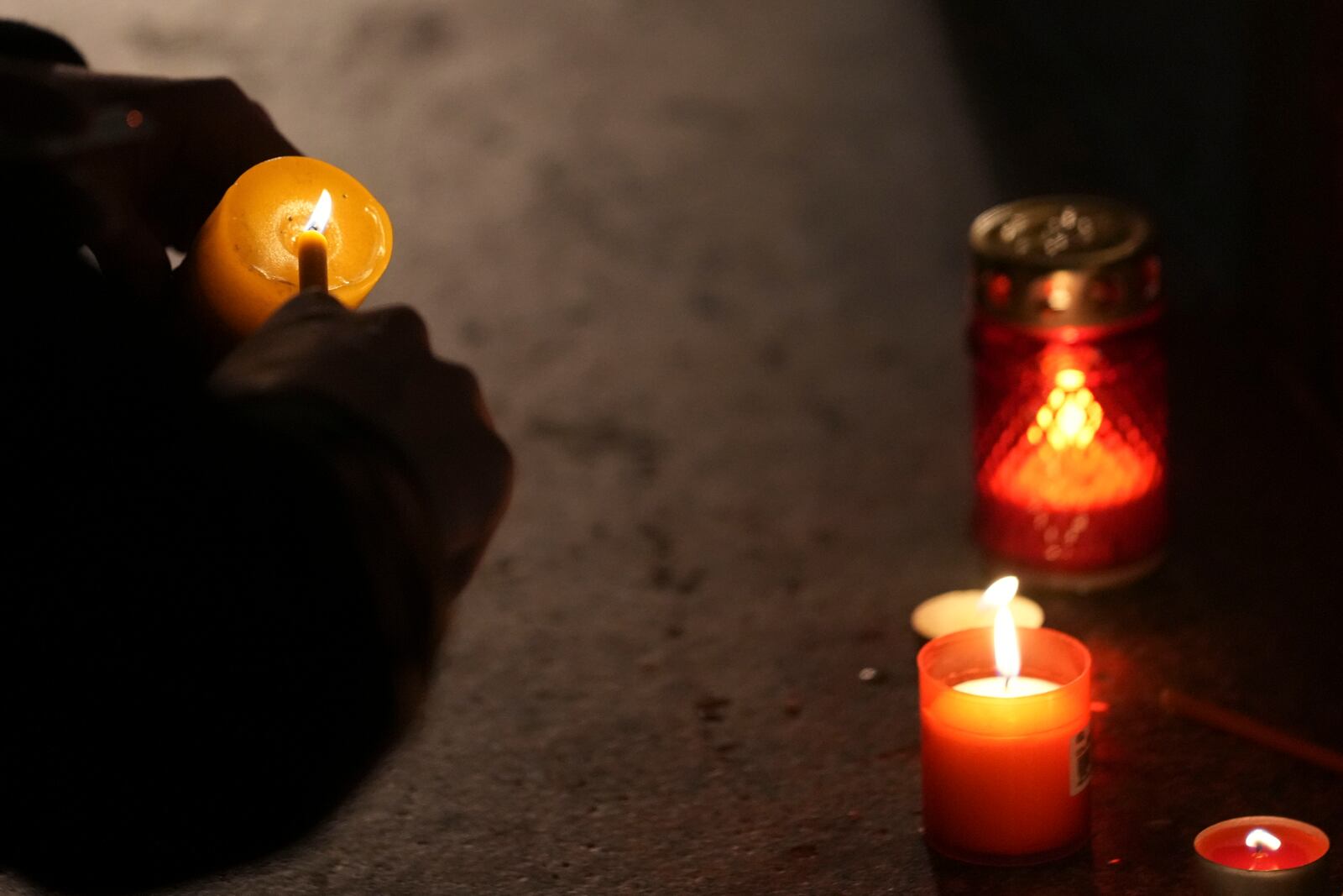 People light candles for the victims after an outdoor roof collapsed at a train station in Novi Sad, Serbia, Friday, Nov. 1, 2024. (AP Photo/Darko Vojinovic)