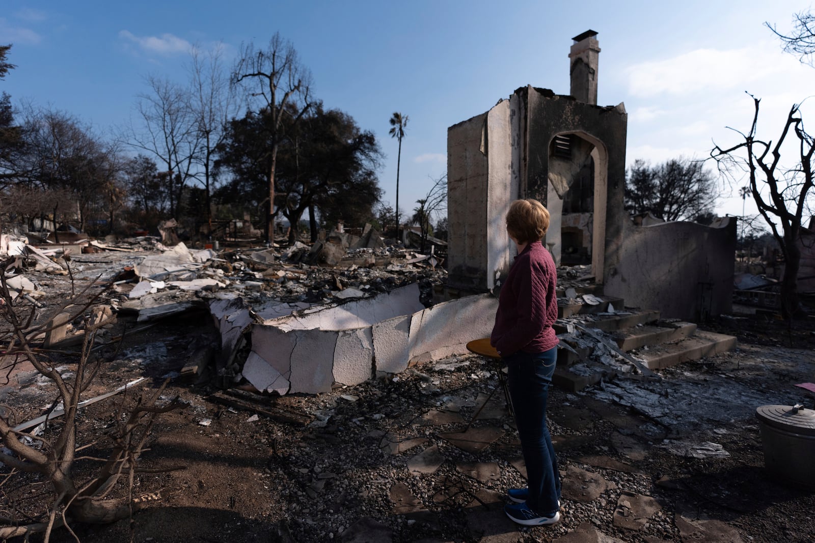 FILE - Louise Hamlin visits her home ravaged by the Eaton Fire in Altadena, Calif., Thursday, Jan. 30, 2025. (AP Photo/Jae C. Hong, File)