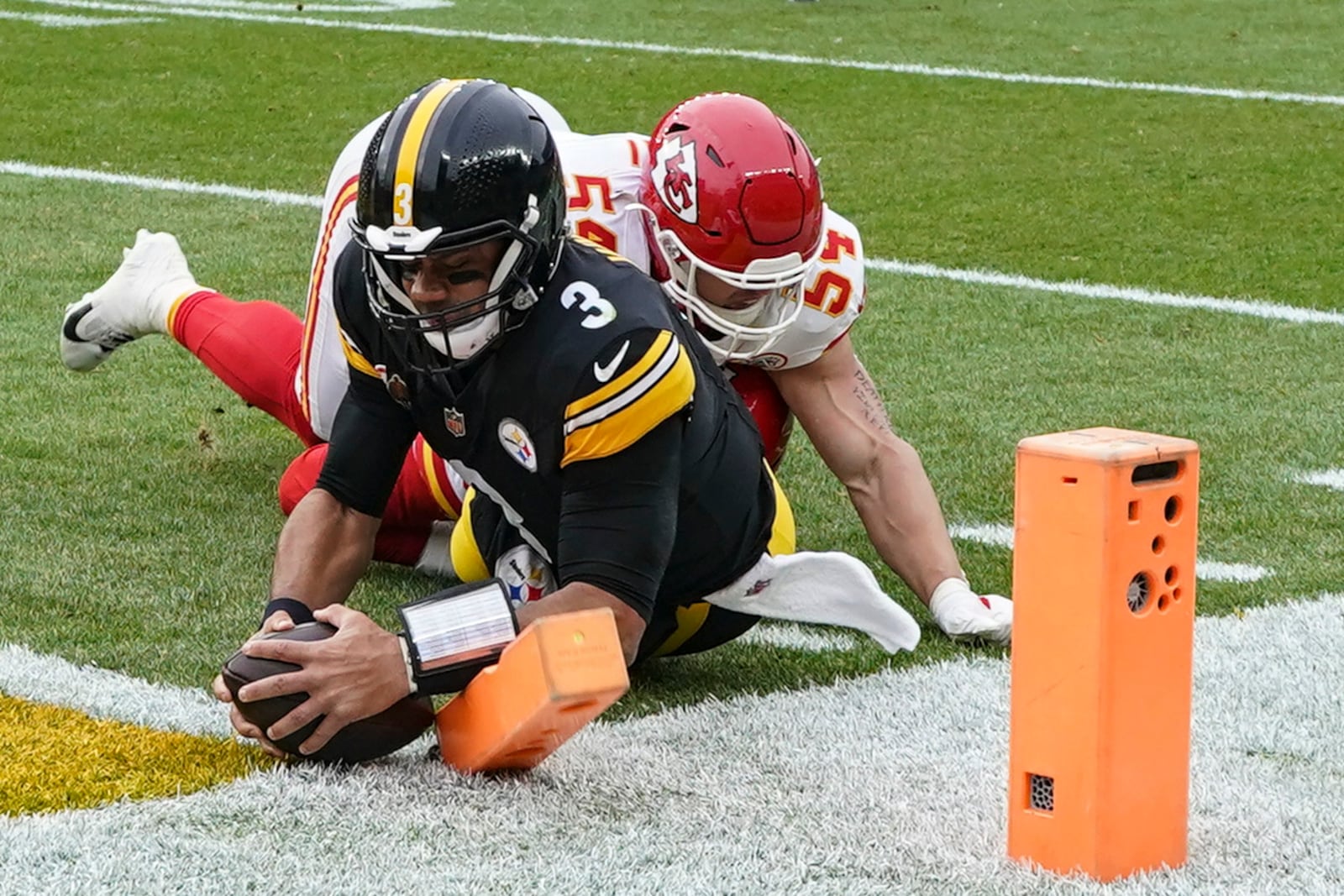 Pittsburgh Steelers quarterback Russell Wilson (3) runs into the end zone for a touchdown against Kansas City Chiefs linebacker Leo Chenal (54) during the first half of an NFL football game, Wednesday, Dec. 25, 2024, in Pittsburgh. (AP Photo/Matt Freed)