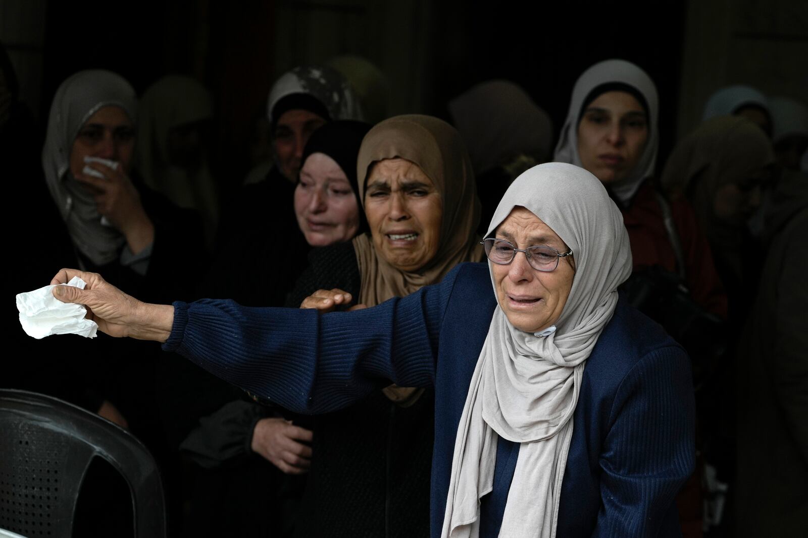 Mourners cry as they attend the funeral of Ahmad Nimer Al-Shaib after he was killed during an Israeli military operation in Jenin, in the West Bank village of Bruqin, Wednesday, Jan. 22, 2025. (AP Photo/Majdi Mohammed)