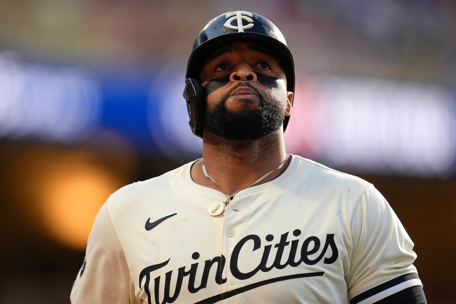 FILE - Minnesota Twins' Carlos Santana walks back to the dugout after hitting a line out to right during the ninth inning of a baseball game against the Baltimore Orioles, Sept. 29, 2024, in Minneapolis. (AP Photo/Abbie Parr, File)