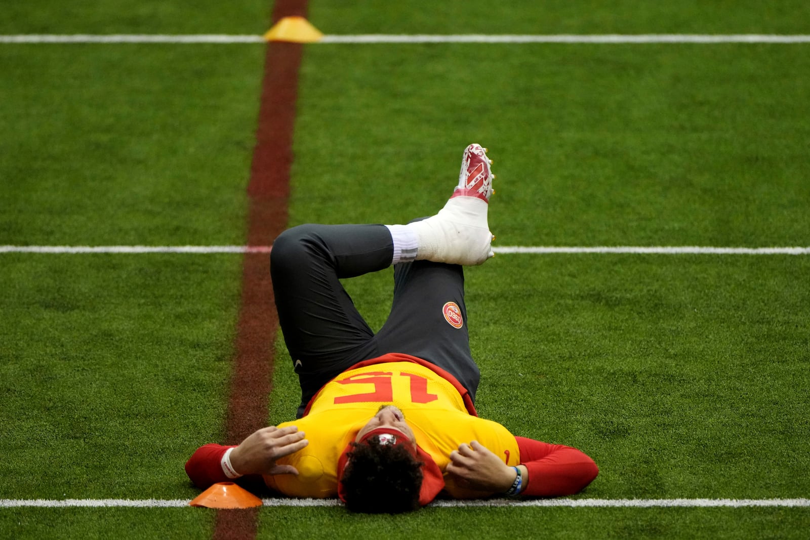 Kansas City Chiefs quarterback Patrick Mahomes stretches during the NFL football team's practice Wednesday, Jan. 22, 2025, in Kansas City, Mo. (AP Photo/Charlie Riedel)