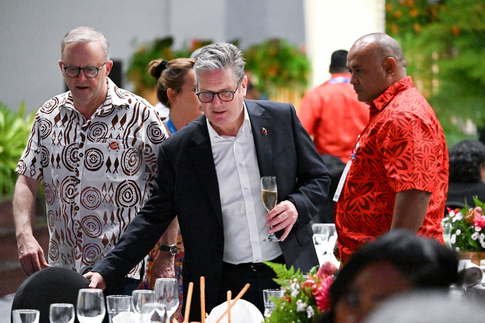 Australia's Prime Minister Anthony Albanese, left, and British Prime Minister Keir Starmer attend a State Banquet during the Commonwealth Heads of Government Meeting (CHOGM) in Apia, Samoa, on Thursday, Oct. 24, 2024. (William West/Pool Photo via AP)