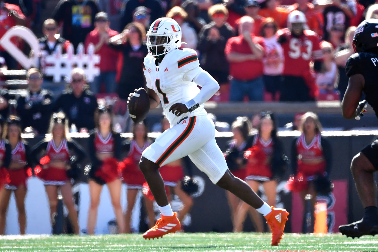 Miami quarterback Cam Ward (1) scrambles for a first down during the first half of an NCAA college football game against Louisville in Louisville, Ky., Saturday, Oct. 19, 2024. (AP Photo/Timothy D. Easley)