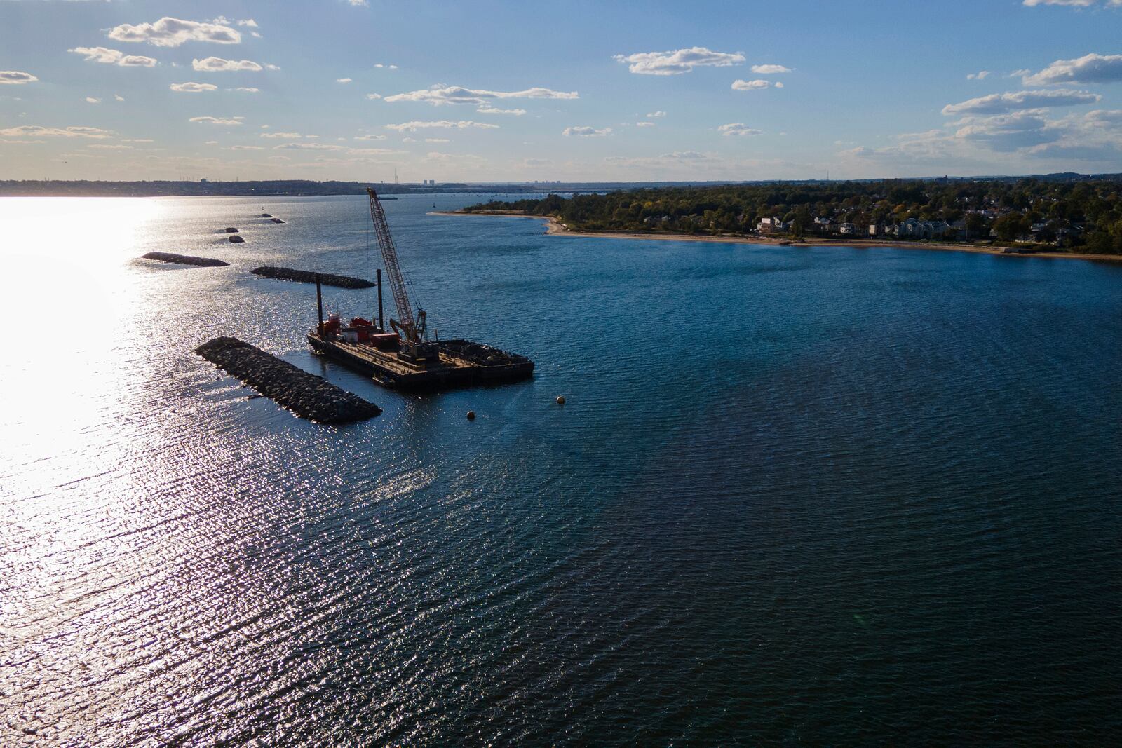 Construction is wrapping up on eight, eco-friendly "Living Breakwaters" at the southernmost tip of New York City, off the coast of Staten Island, Wednesday, Oct. 9, 2024, where artificial reefs were constructed as part of a strategy to reduce risk from hurricanes after Superstorm Sandy pummeled the region in 2012. (AP Photo/Ted Shaffrey)